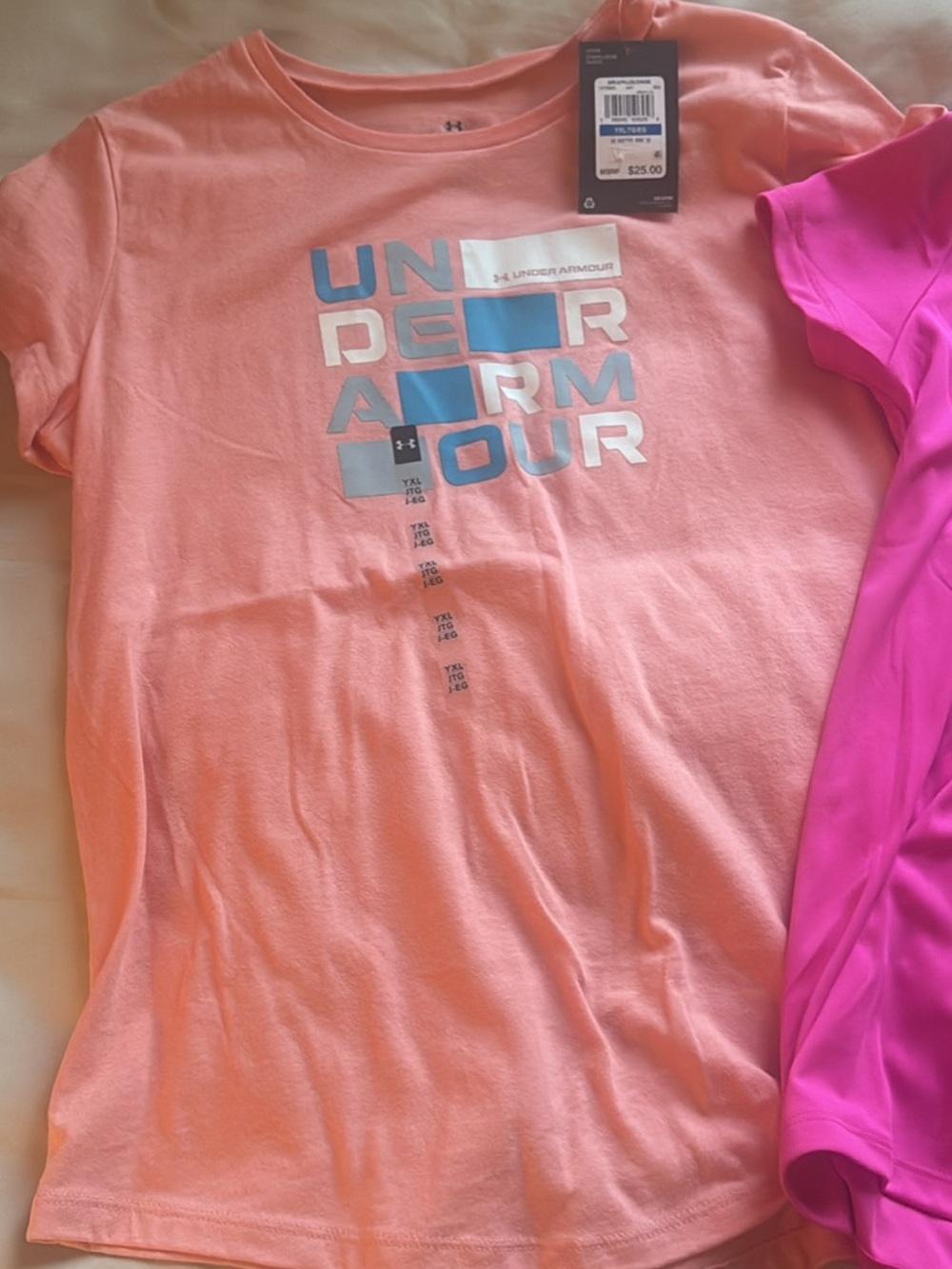 Under Armour Girls' Peach Short Sleeve Logo Tee with Blue Accents